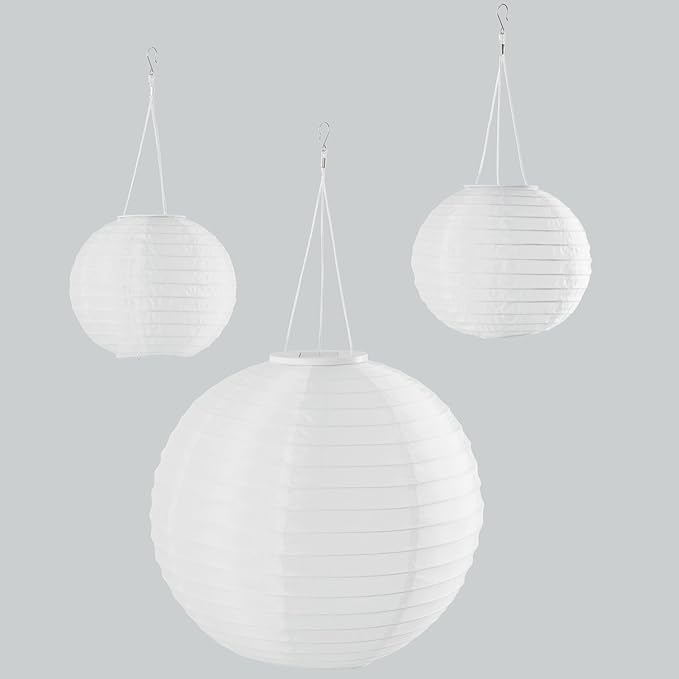 Three white spherical hanging lamps on a light gray background