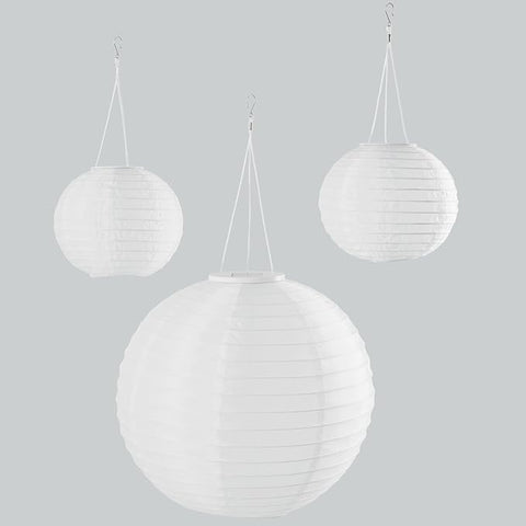 Three white spherical hanging lamps on a light gray background