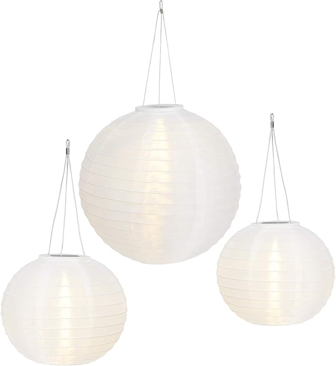 Three white spherical pendant lights hanging against a white background