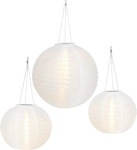 Three white spherical pendant lights hanging against a white background