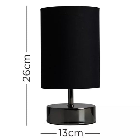 Lamp emitting warm light in a cozy bedroom setting.​



