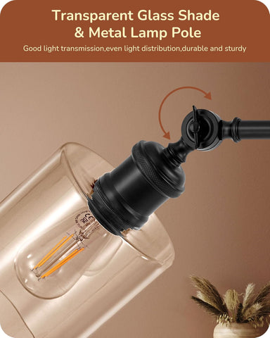 Transparent glass shade and metal lamp pole with light bulb on a beige background