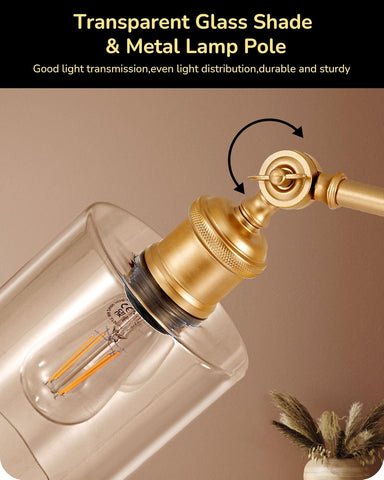 Transparent glass shade and metal lamp pole with text on a beige background