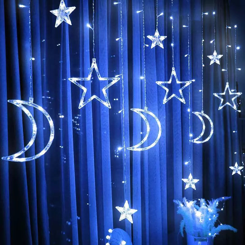 Curtain lights with moon and star patterns in soft glow

