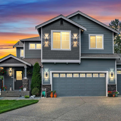 Two-story house with gray exterior and garage at sunset