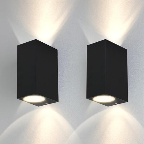 Two black square wall lights on a white wall