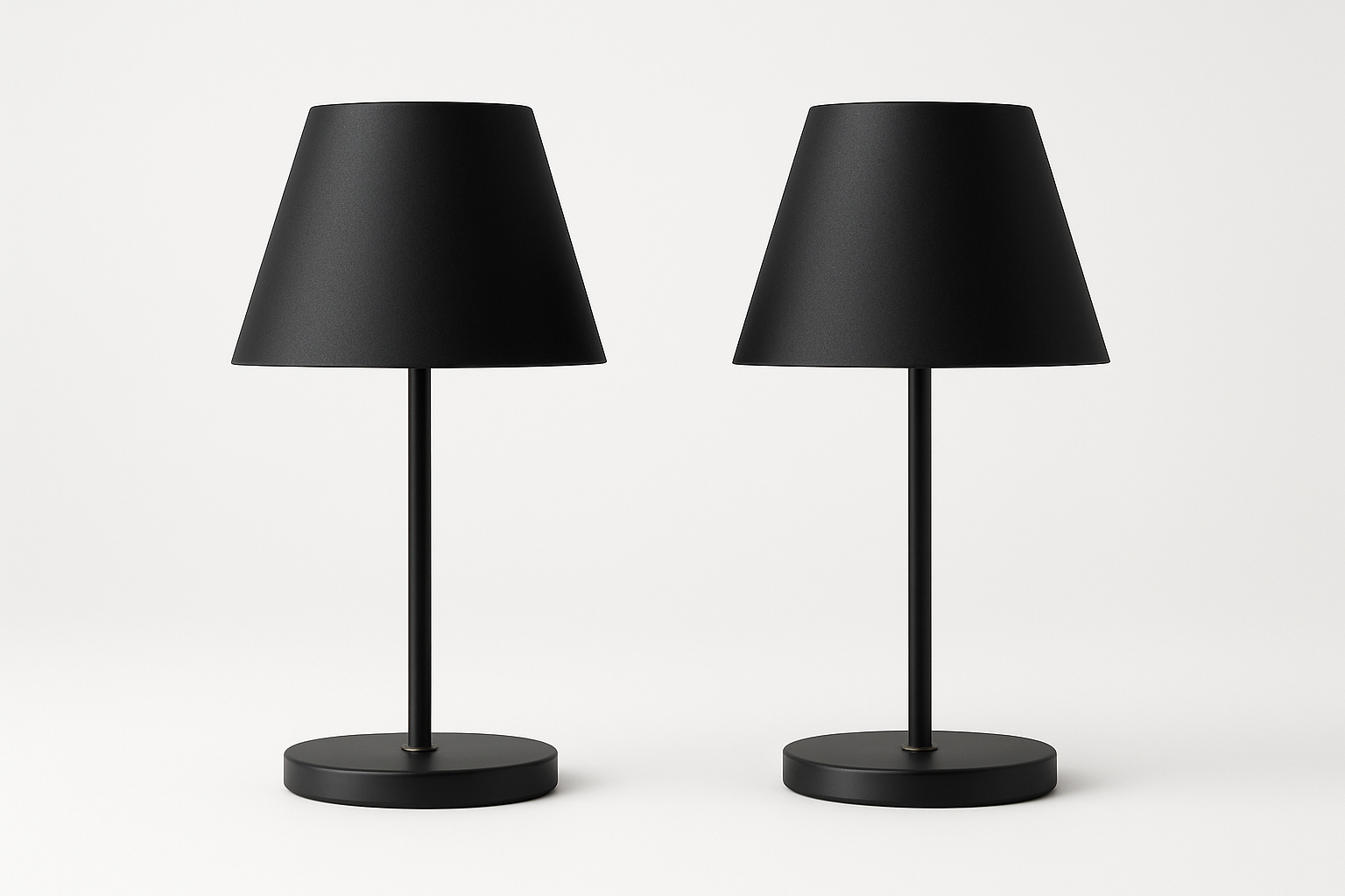 Two black table lamps on a white background