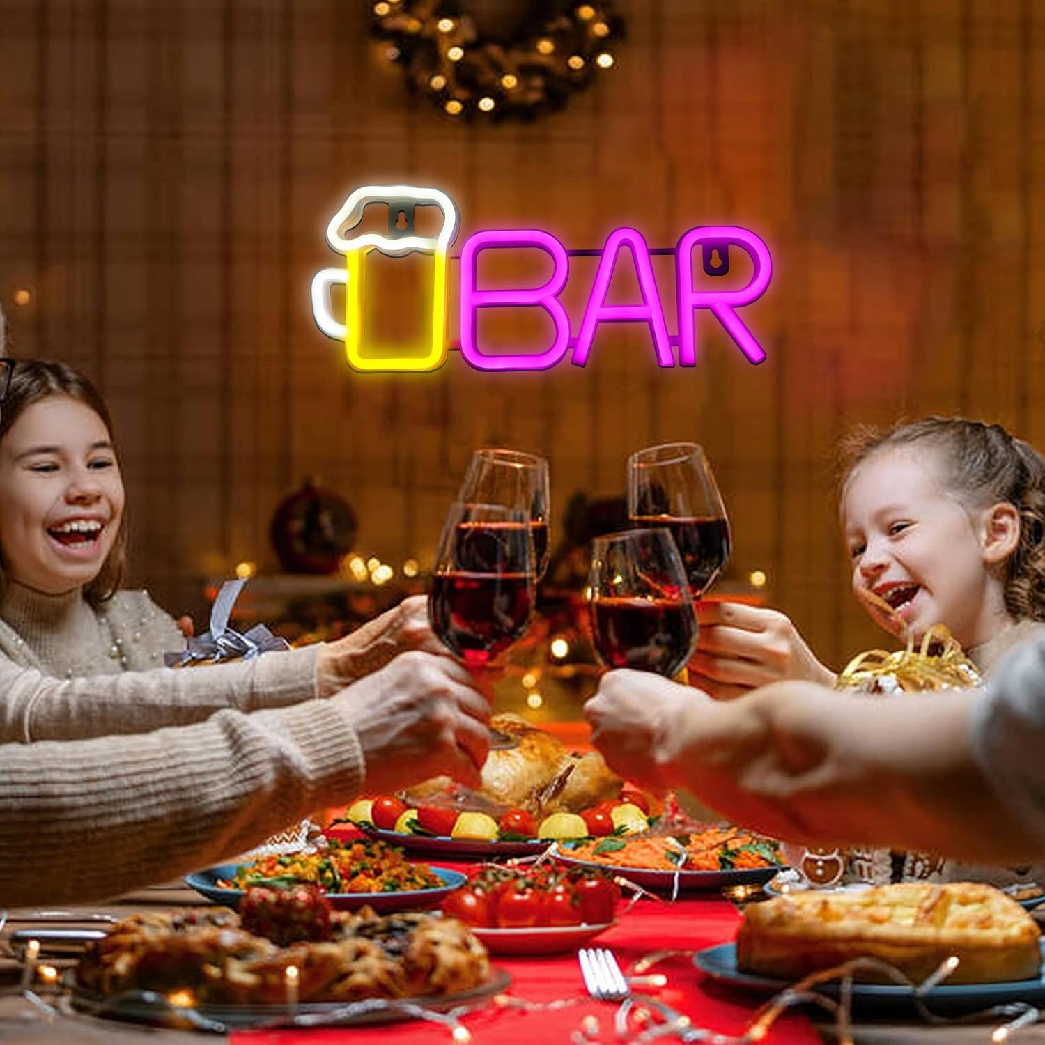 Two children enjoying a meal with wine glasses in front of a 'U Bar' neon sign.