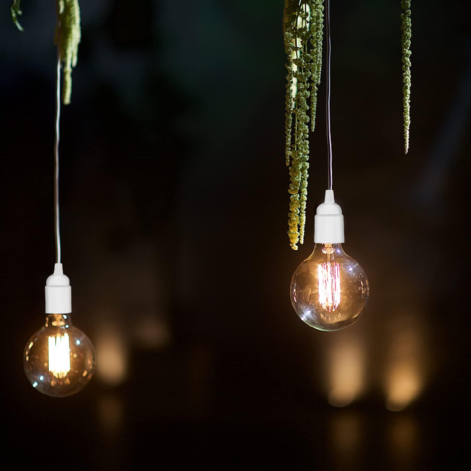 Two hanging light bulbs with a dark background
