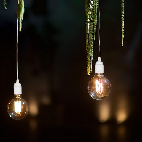 Two hanging light bulbs with a dark background
