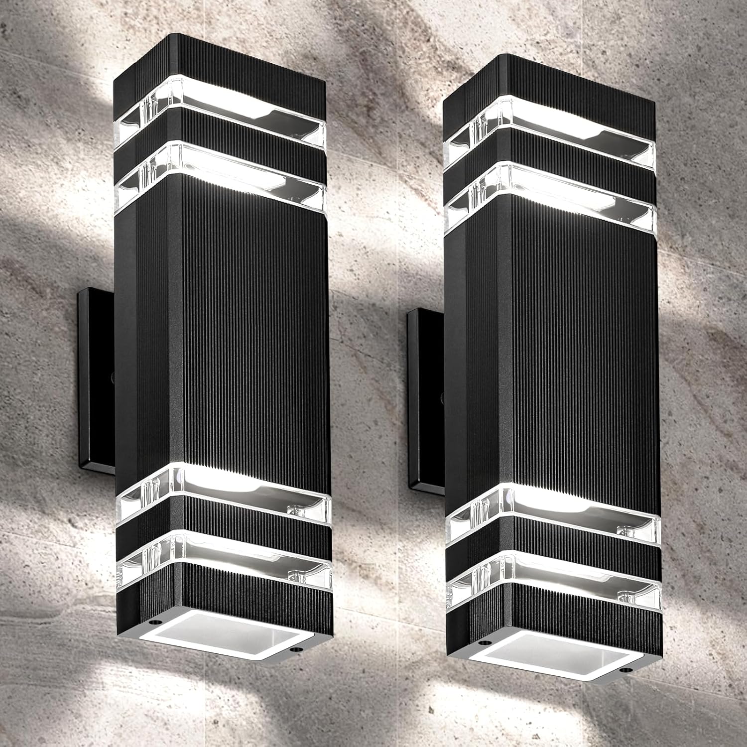 Two modern black wall lights on a concrete wall.