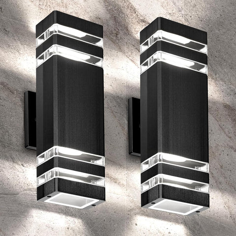 Two modern black wall lights on a concrete wall.