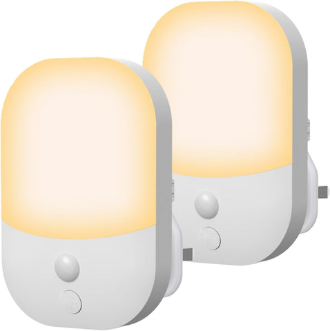 Two motion sensor night lights with a white base and yellow light on a white background.