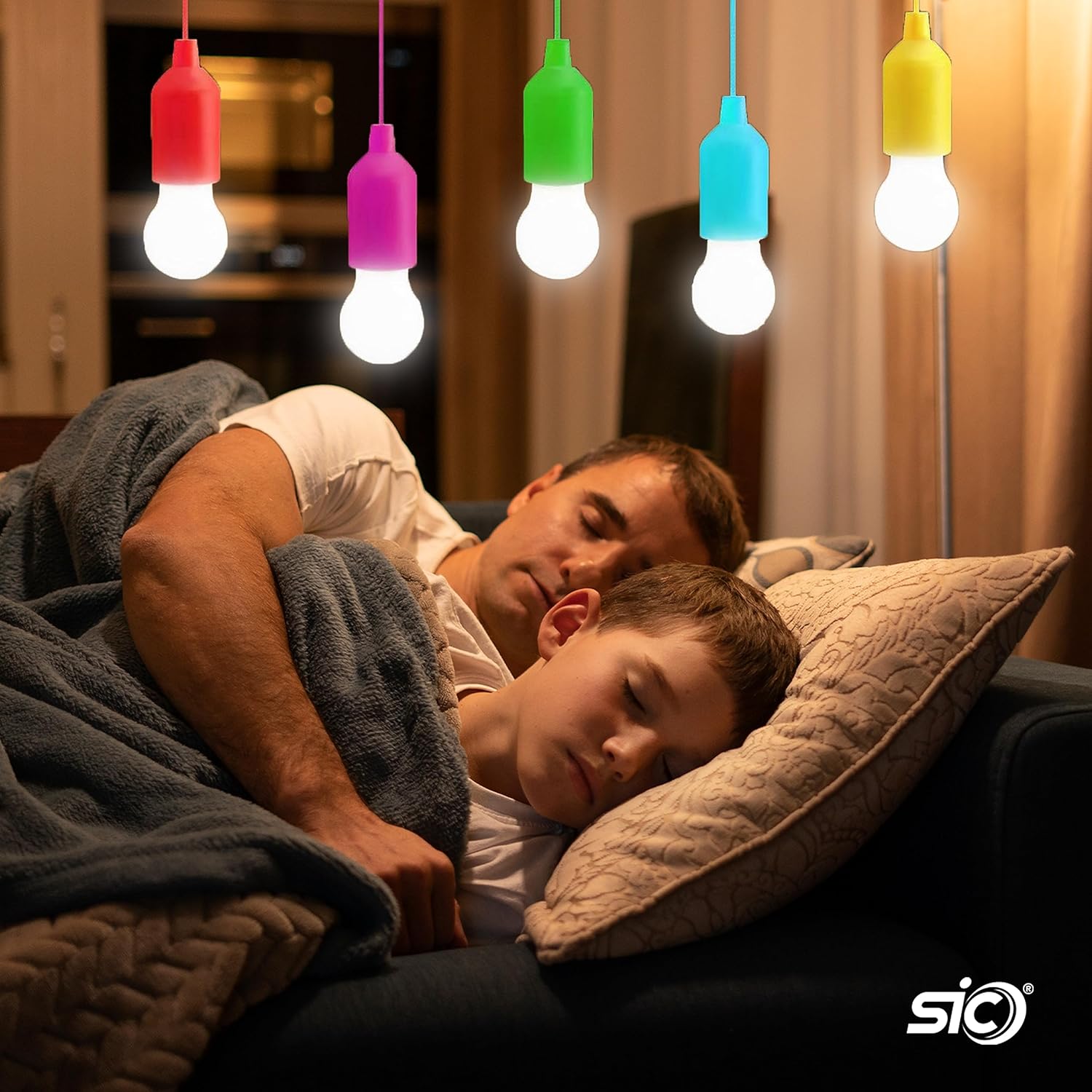 Two people lying down under a blanket with colorful hanging light bulbs above them, featuring the brand 'sio'.