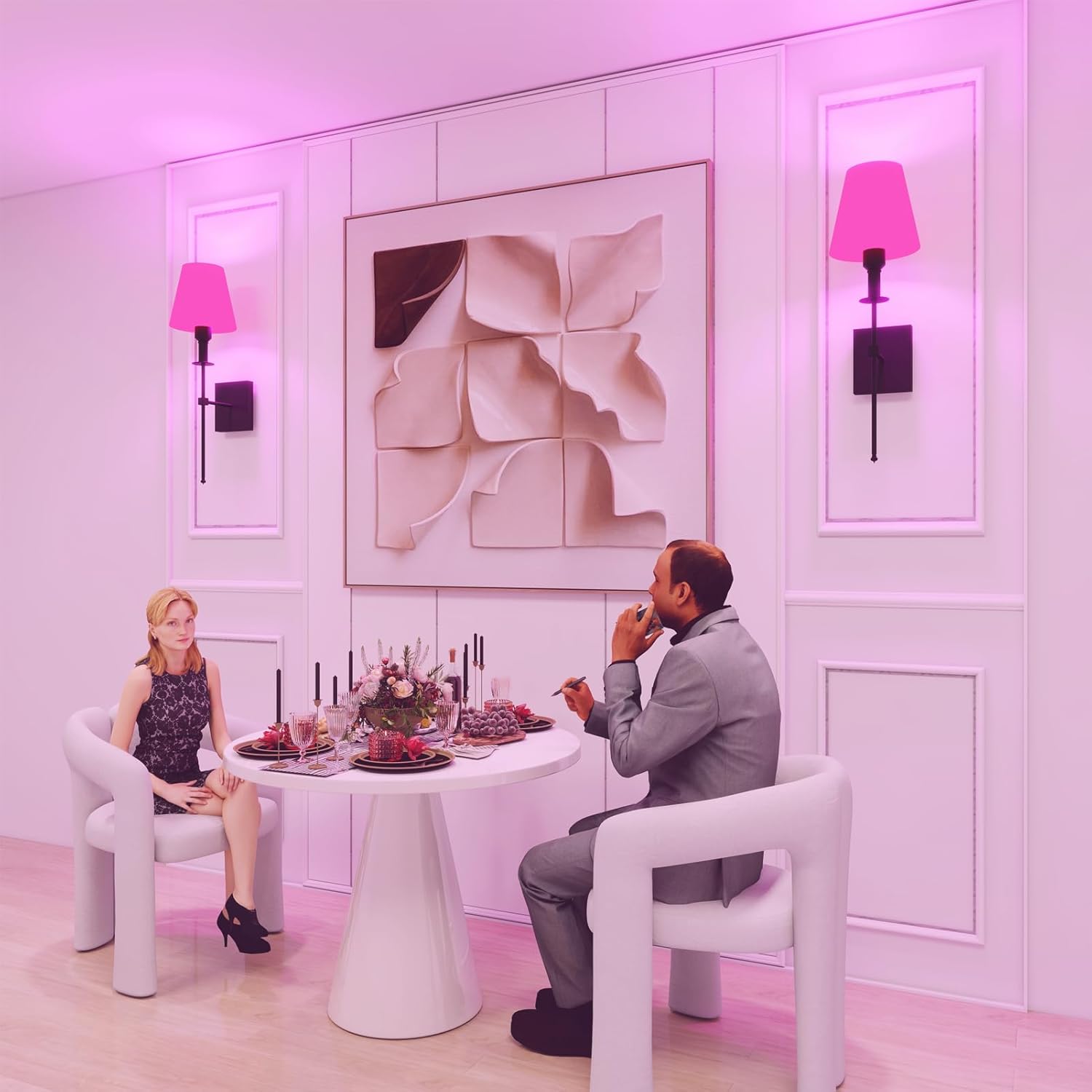 Two people sitting at a table in a stylish room with pink lighting.
