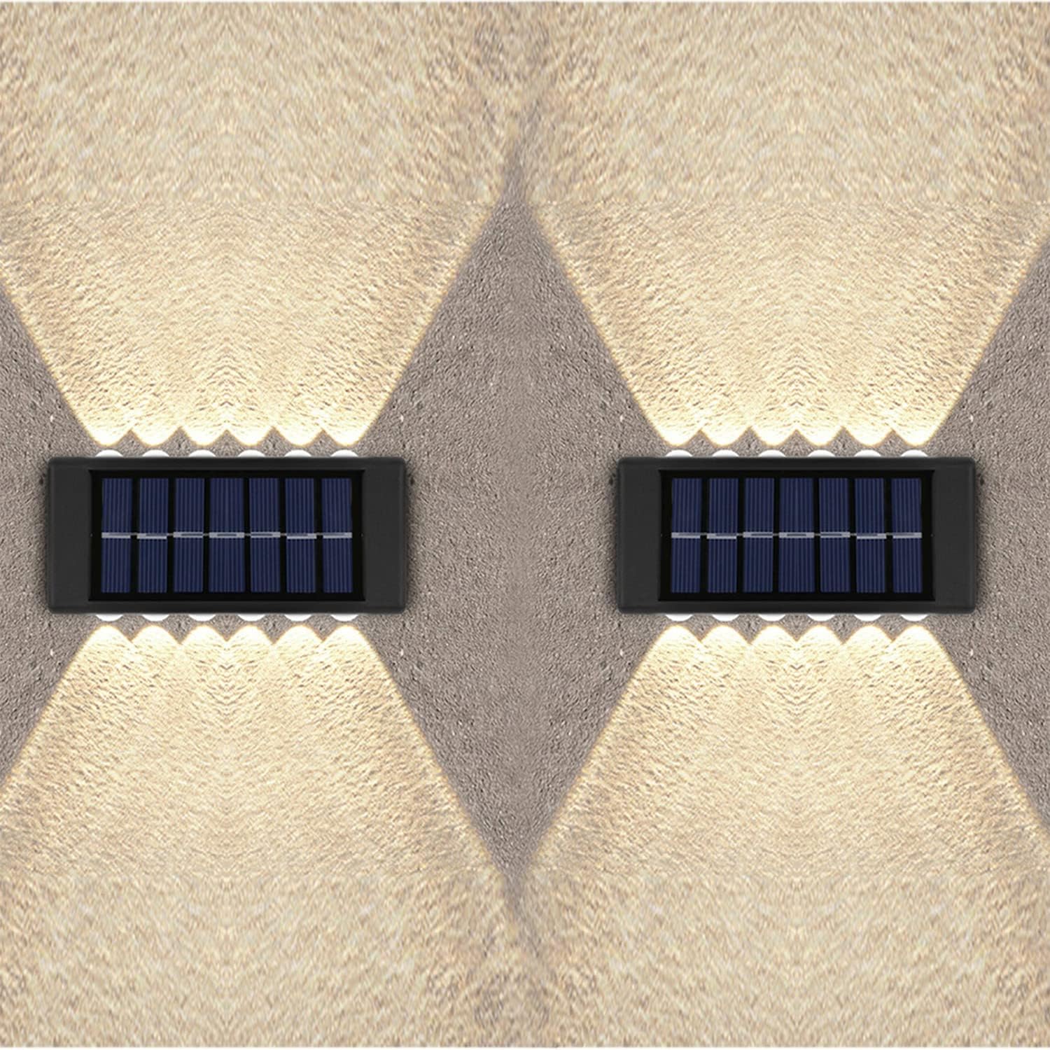 Two solar-powered wall lights on a textured wall.