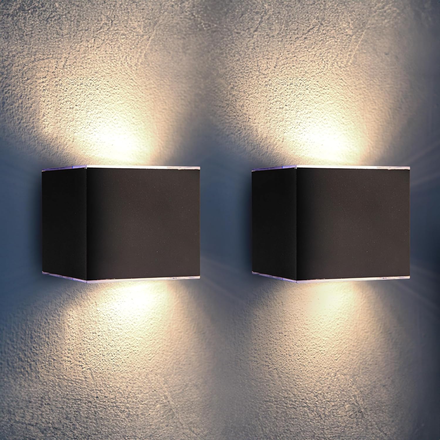 Two square wall lights on a textured wall