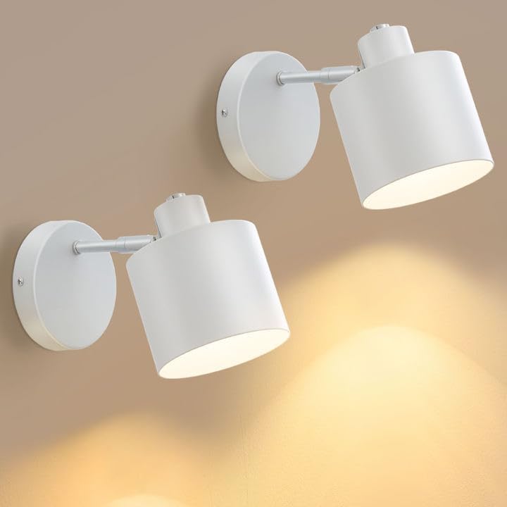 Two white wall-mounted spotlights on a beige wall.