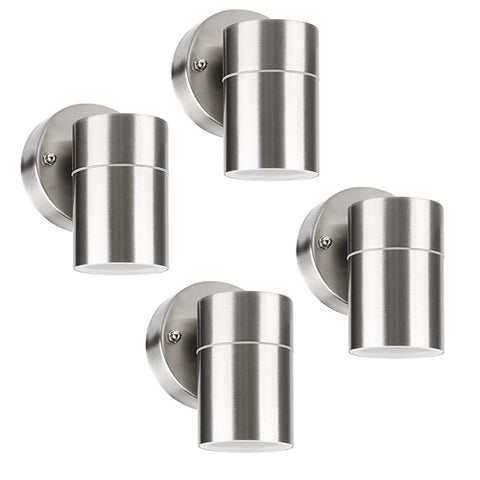 Front view of a modern stainless steel outdoor wall light in a garden setting

