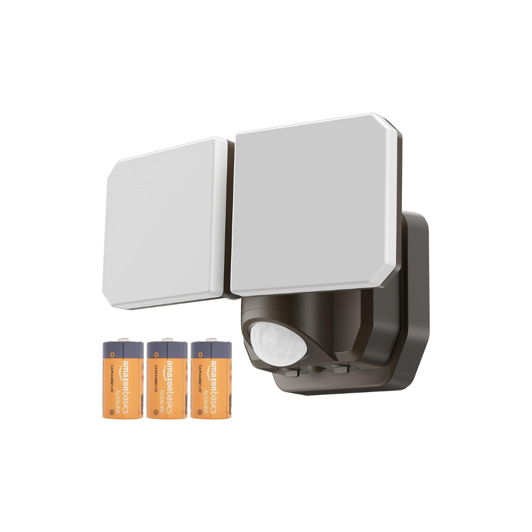 Outdoor security light with motion sensor and batteries on a white background