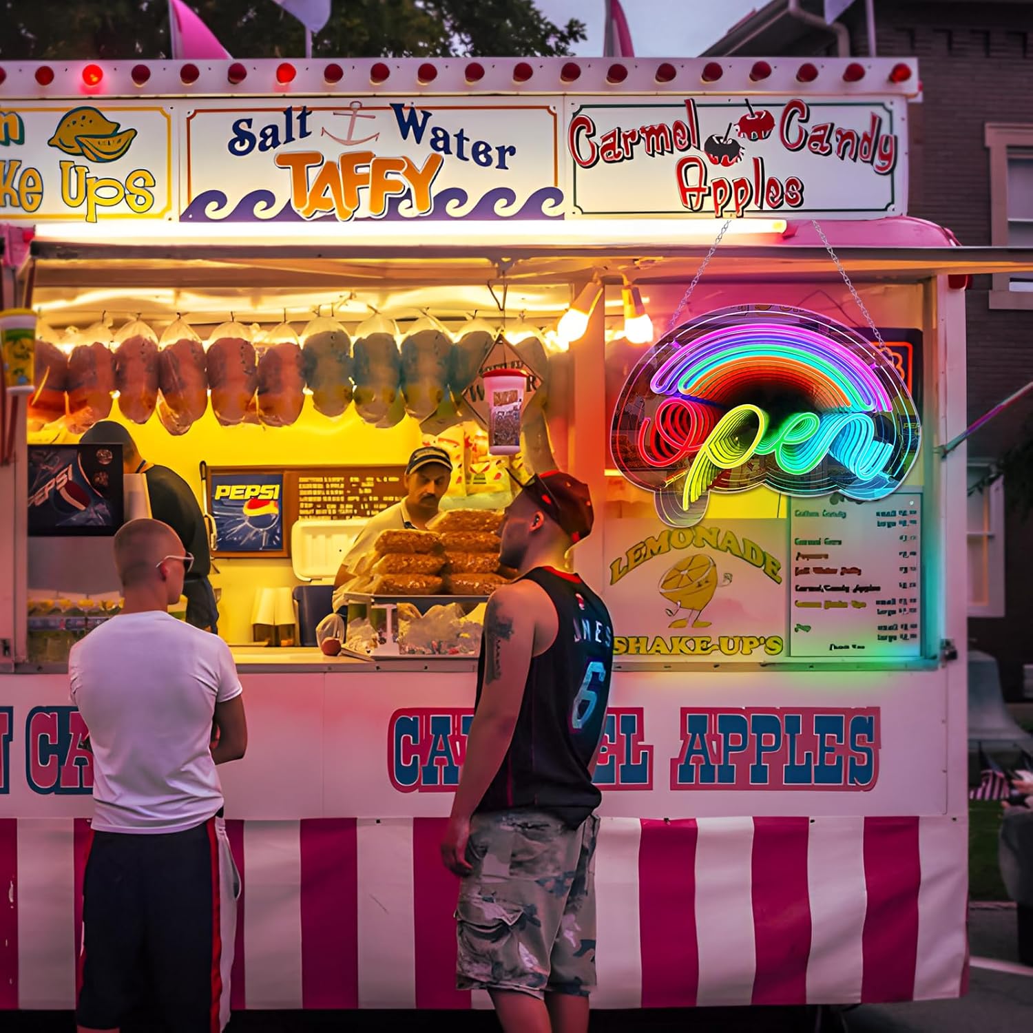 Vibrant food truck with colorful signage and a rainbow-colored lemonade stand sign.