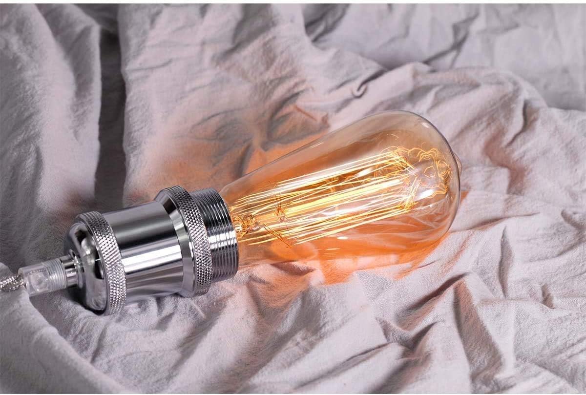 Vintage-style light bulb on a textured fabric background