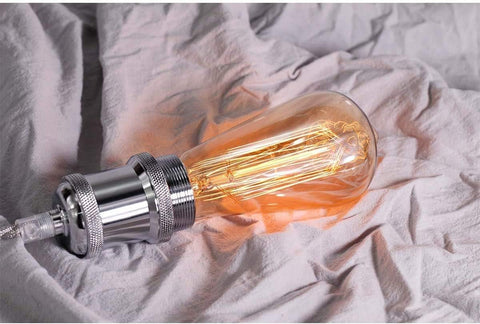 Vintage-style light bulb on a textured fabric background
