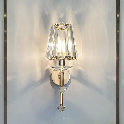 Wall-mounted lamp with crystal shade on a white wall