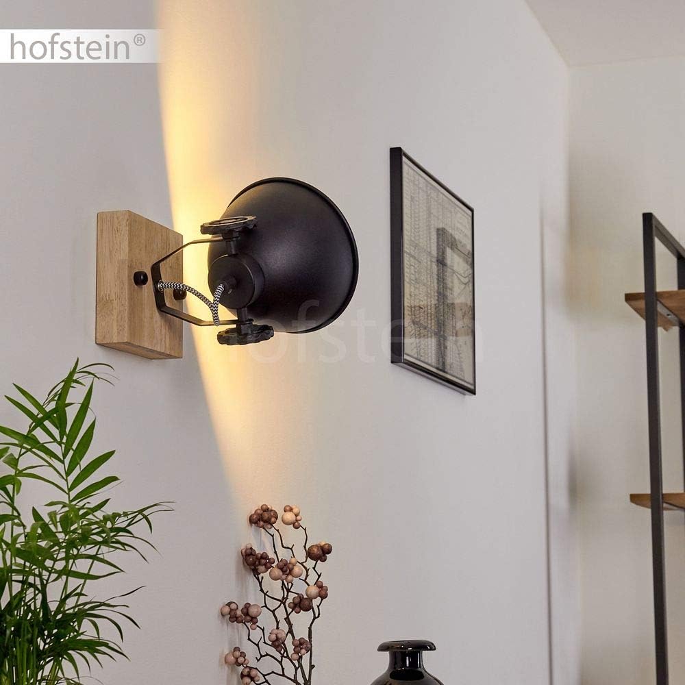 Wall-mounted lamp with wooden bracket in a room setting.