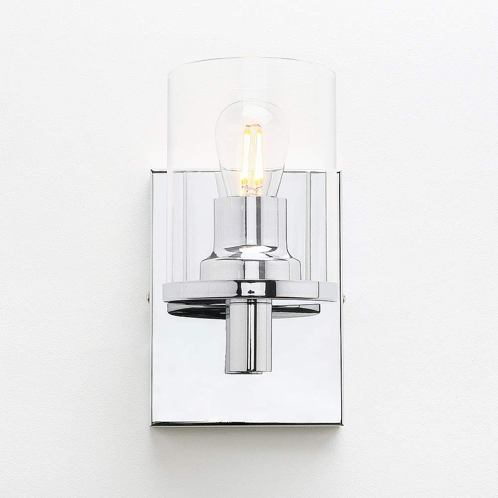 Wall-mounted light fixture with clear glass shade on a white background