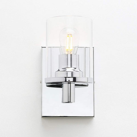 Wall-mounted light fixture with clear glass shade on a white background