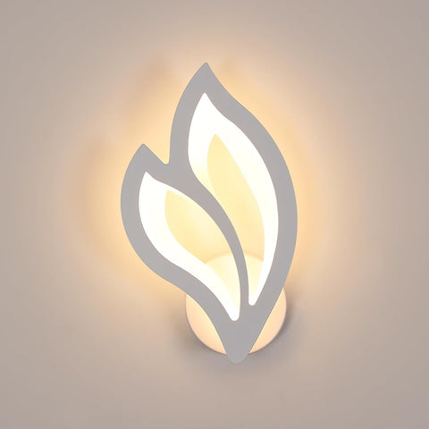 Wall-mounted light fixture with leaf design on a neutral background