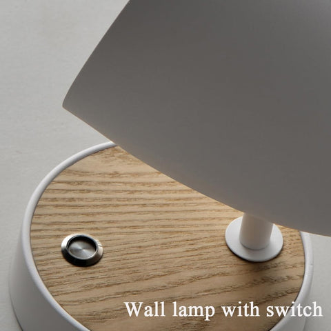 Wall lamp with wooden base and switch on a neutral background