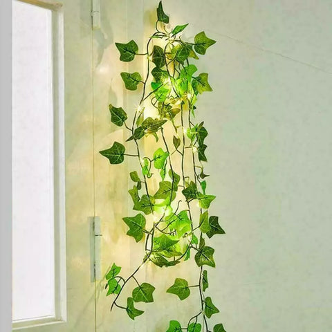 Ivy garland with fairy lights wrapped on headboard

