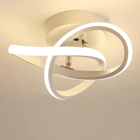 Modern ceiling light fixture with circular design on a plain background