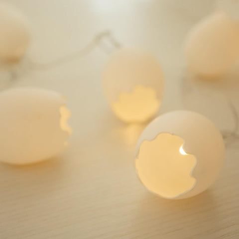 Warm white broken egg LED string lights displayed on mantel