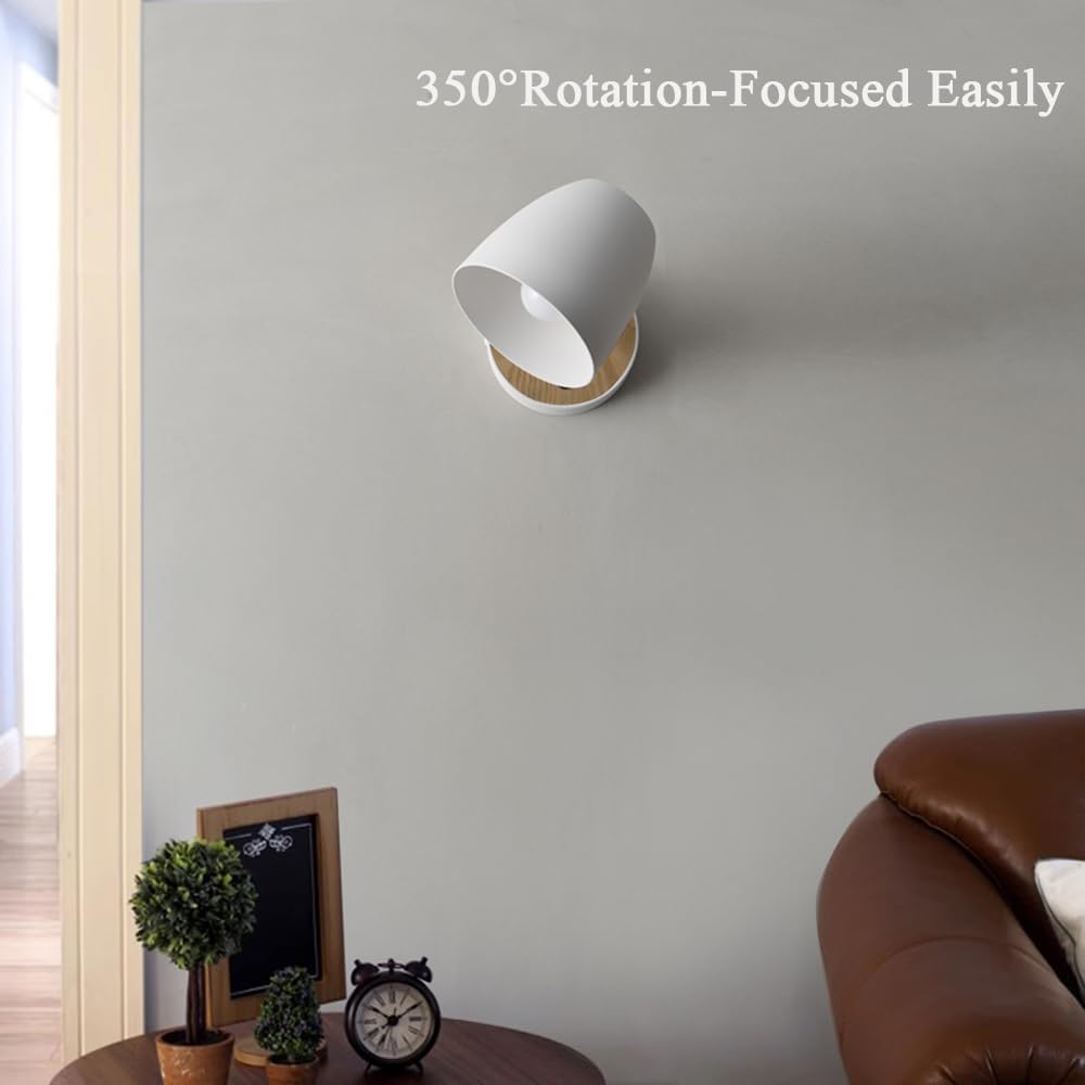 White wall-mounted lamp with 350-degree rotation feature in a room setting.