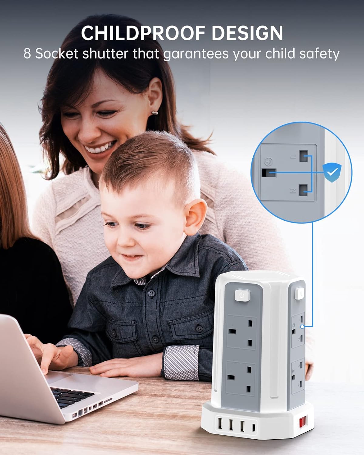 Woman and child using a laptop with a childproofed electrical outlet in the foreground.
