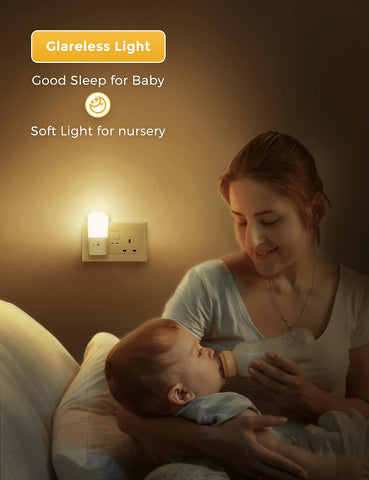Woman feeding a baby with a bottle in a softly lit room, featuring a night light.