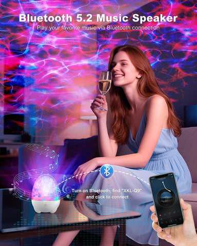 Woman holding a glass of wine with a Bluetooth music speaker and smartphone in a colorful room.