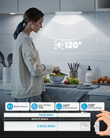 Woman preparing food in a kitchen with a motion sensor light above her head.