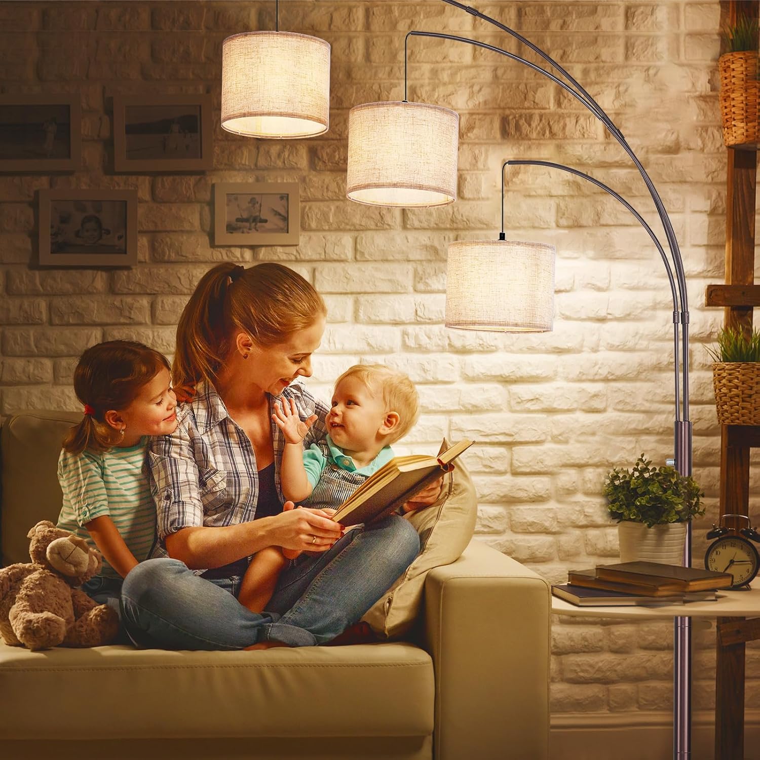 Woman reading a book to two children in a cozy living room.