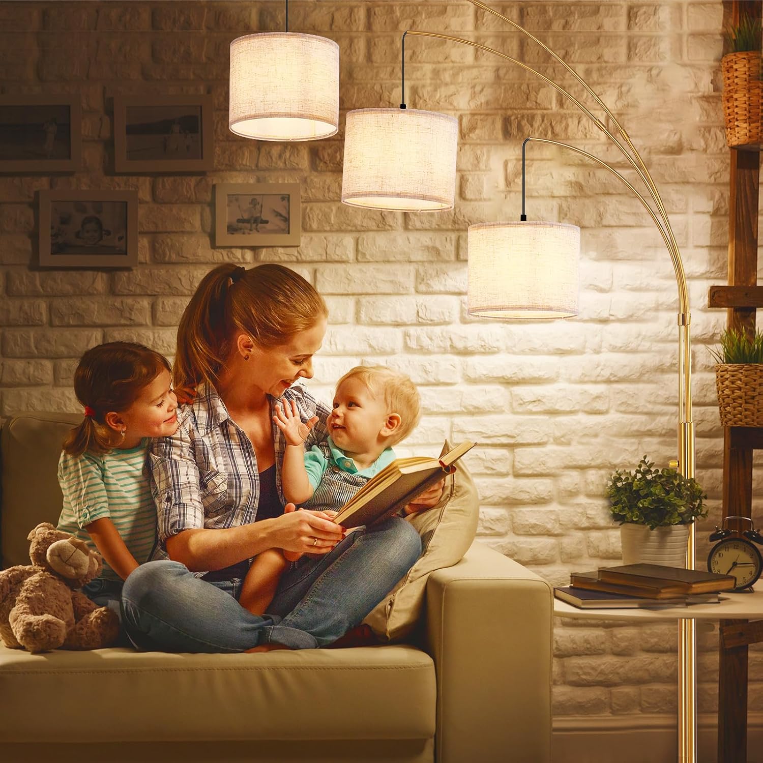Woman reading a book to two children on a couch in a cozy living room.