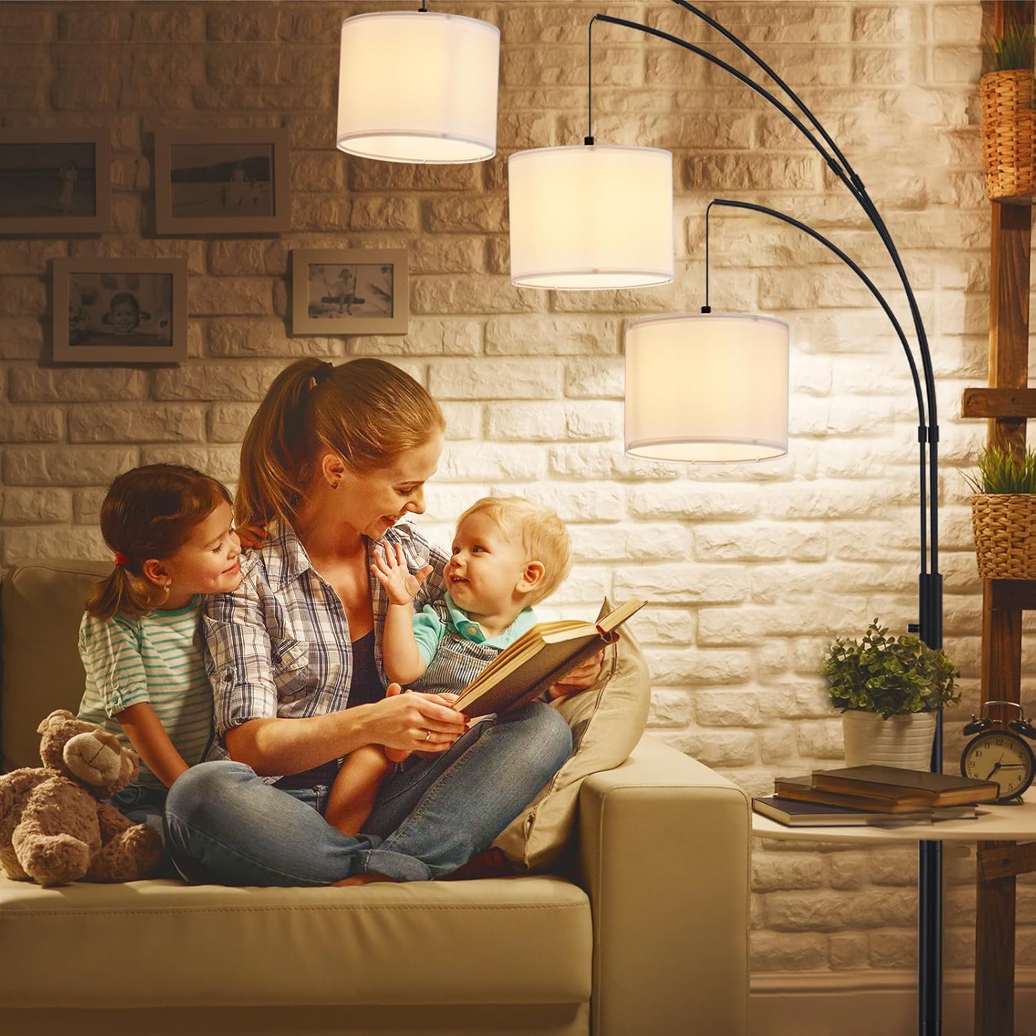 Woman reading a book to two children in a cozy living room.