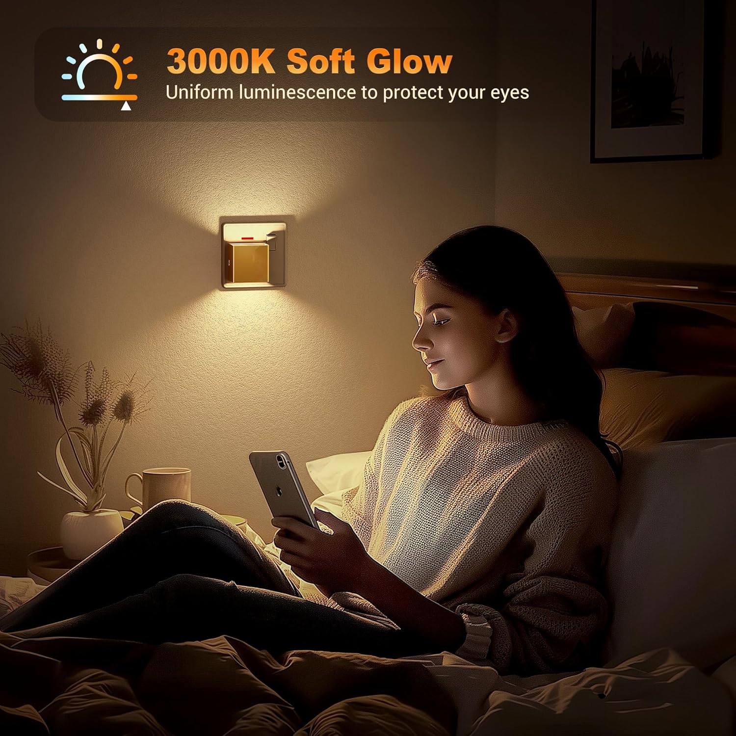 Woman sitting on a bed using a smartphone with a soft glow light fixture above her.