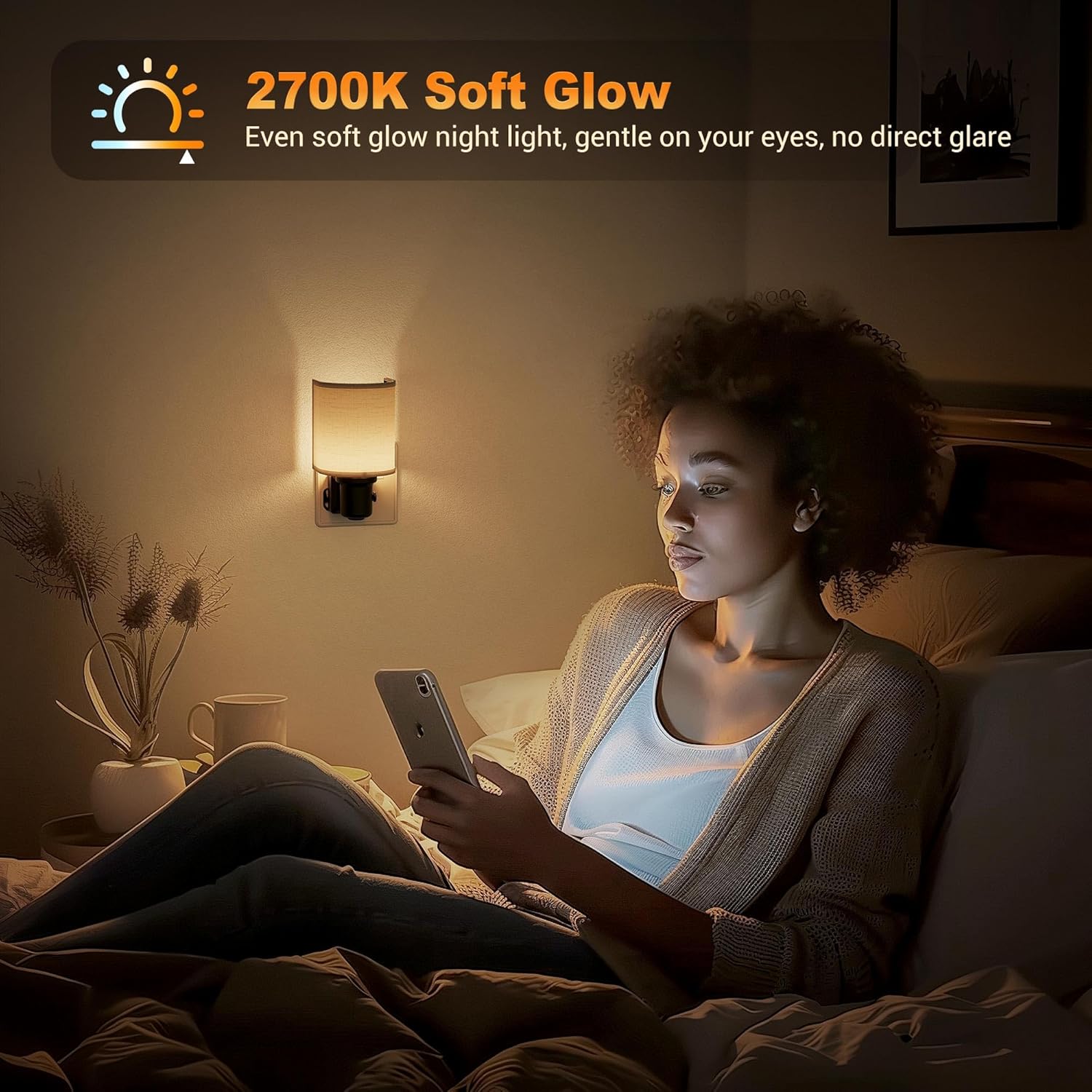 Woman using a smartphone in a dimly lit room with a night light on the wall.