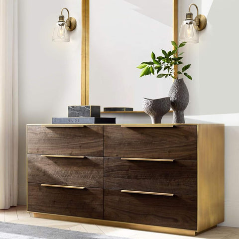 Wooden dresser with gold accents in a modern room setting