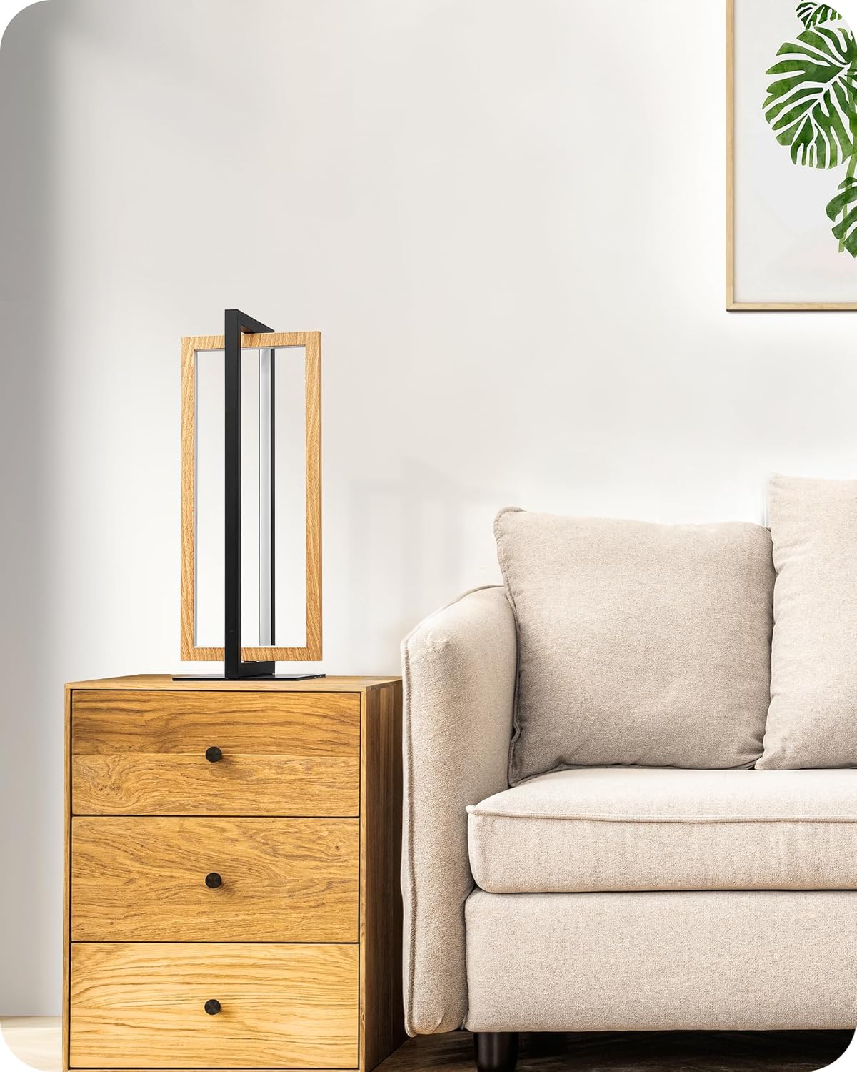 Wooden side table with a lamp next to a beige sofa in a living room setting.