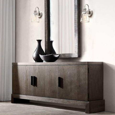 Wooden sideboard with decorative vases and a mirror in a room setting.