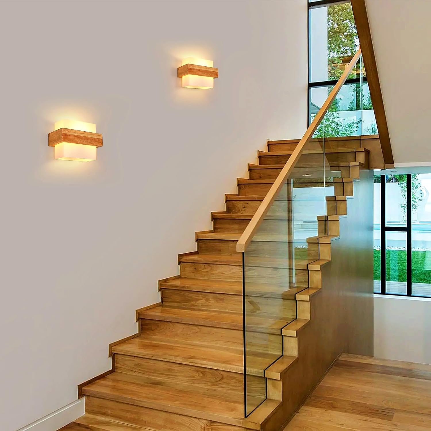 Wooden staircase with glass railings in a modern interior setting.